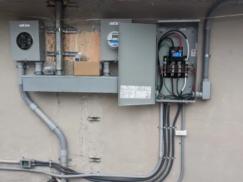 A newly installed electrical panel on the exterior of a building in Miami Beach, showcasing secure and efficient wiring connections to ensure reliable power distribution.