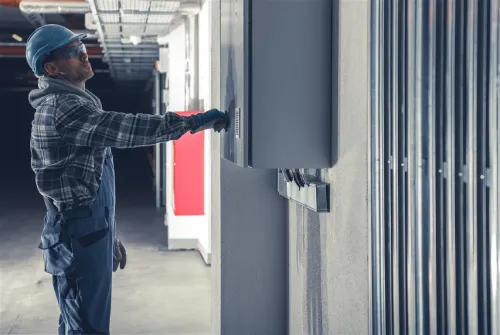 A professional electrician in Miami Beach performing maintenance on a fuse box, ensuring the electrical system is operating safely and efficiently.